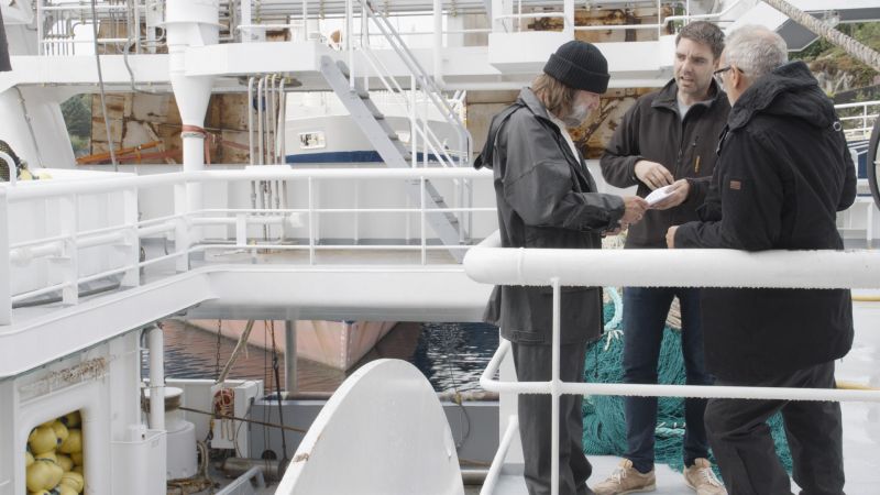 Regissør Petter Misje instruerer skuespillerne Mike McGurk fra Bømlo (t.v) og John McMillan fra Stord (t.h) under innspillingen i Austevoll.